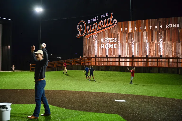 The Home Run Dugout beer garden baseball field at night